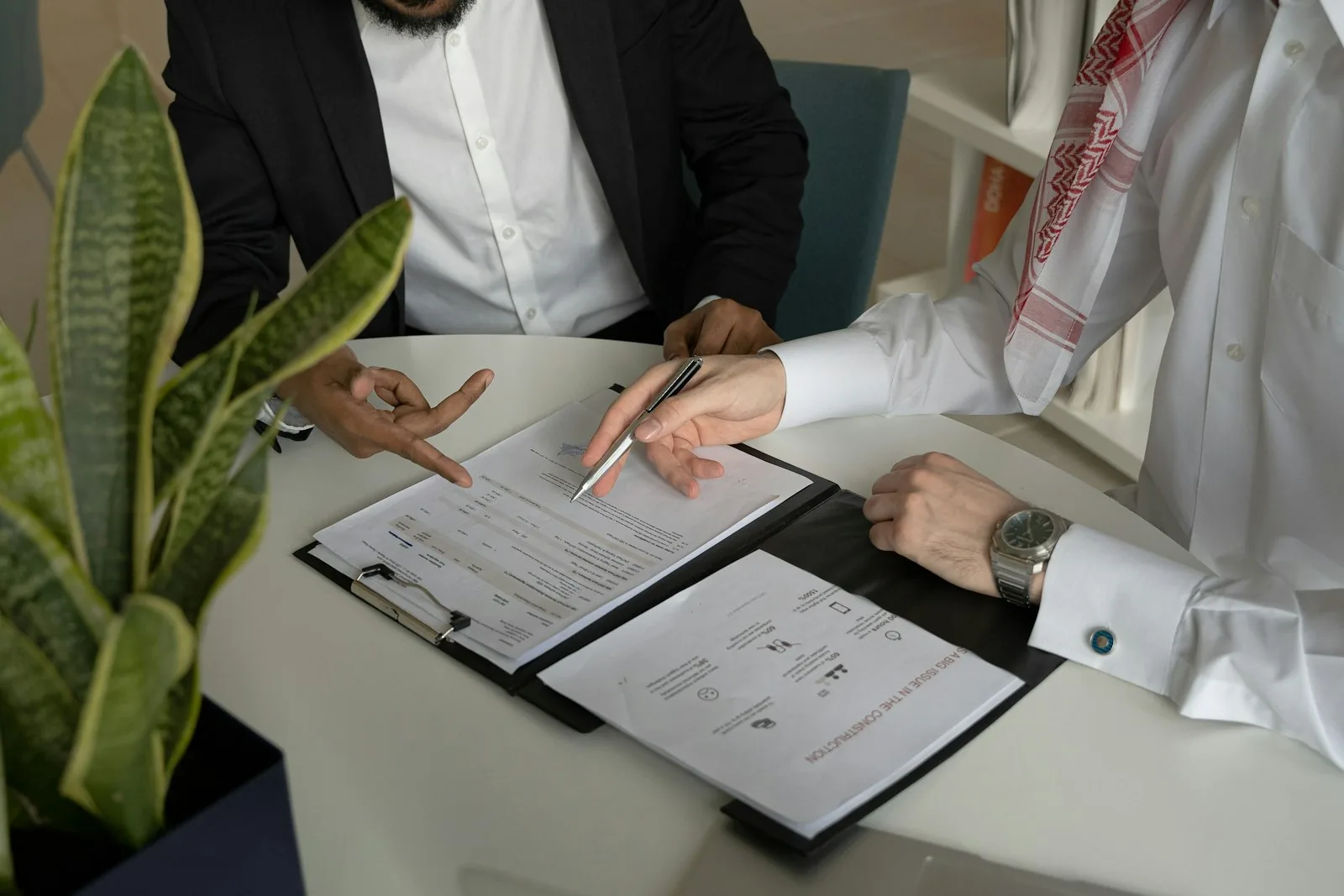 Company documents being reviewed at a meeting table