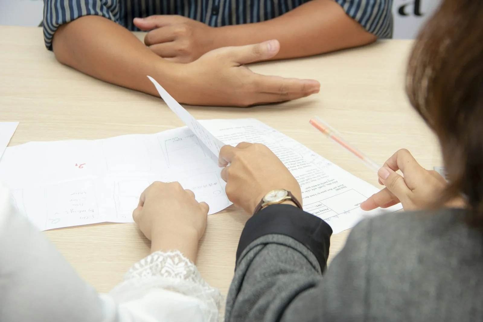 Several people reviewing company paperwork at a table